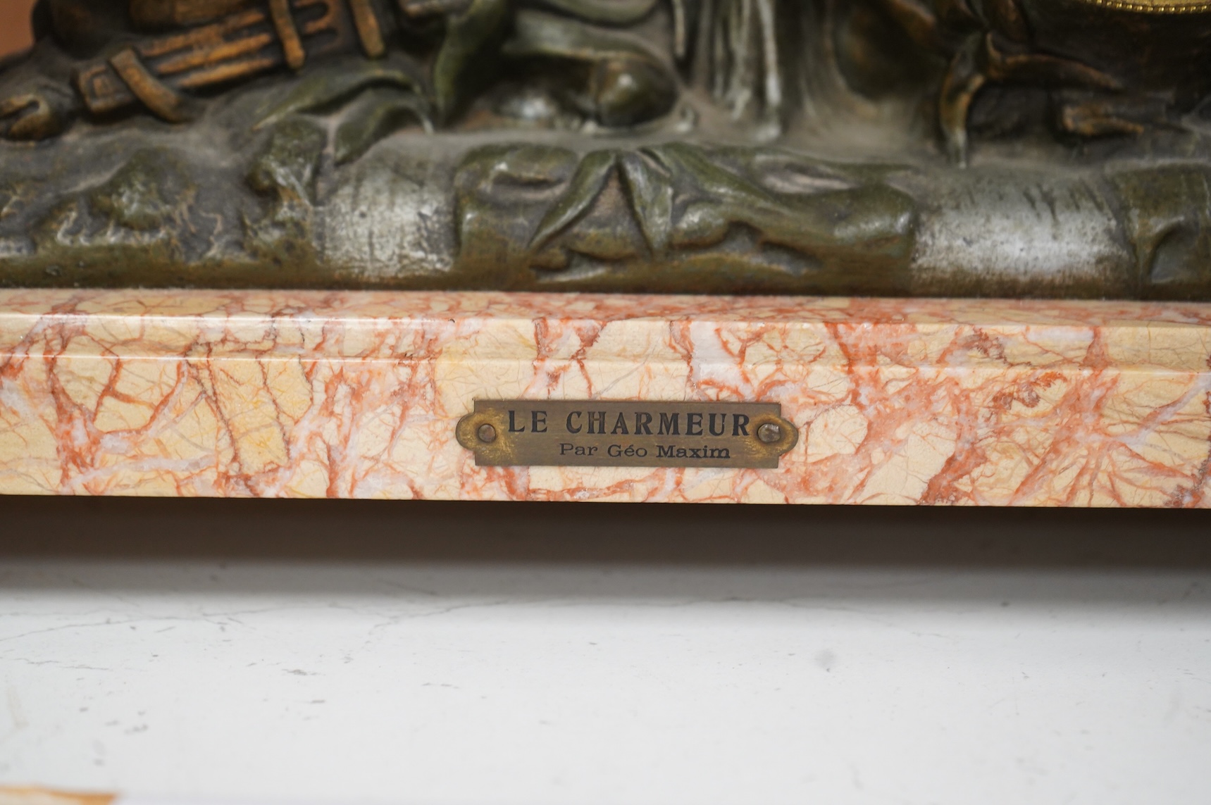 After Georges Maxim (French, 1885-1940), ‘Le Charmeur’, an early 20th century gilt spelter and rouge marble mantel clock, 39cm wide